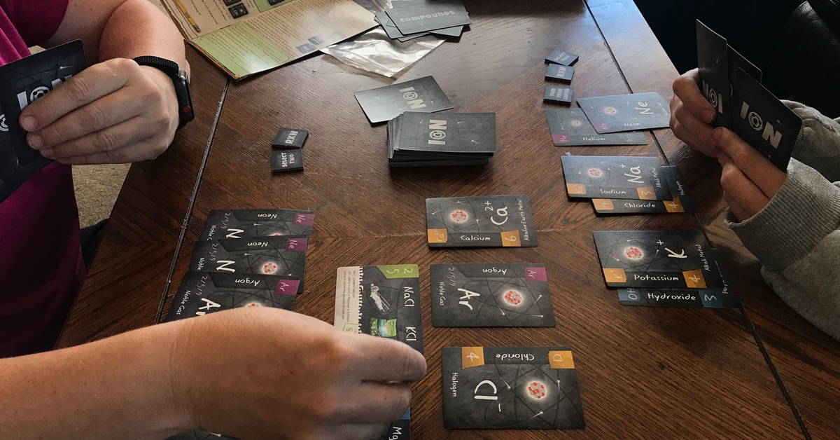 teens playing "Ion" board game